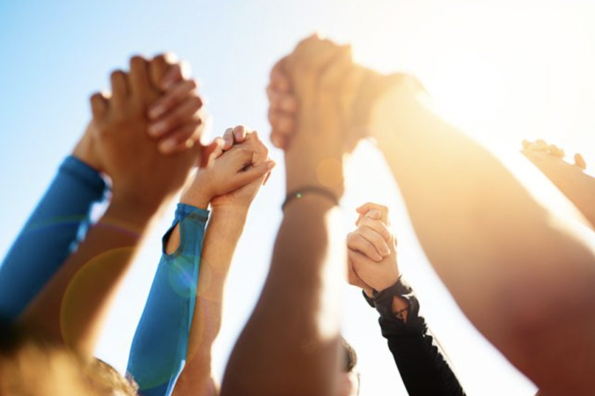 Hands raised together toward the light